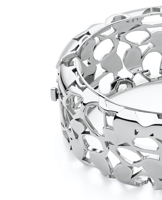 Shiny silver heritage bangle with intricate openwork design, perfect for stylish accessory lovers.
