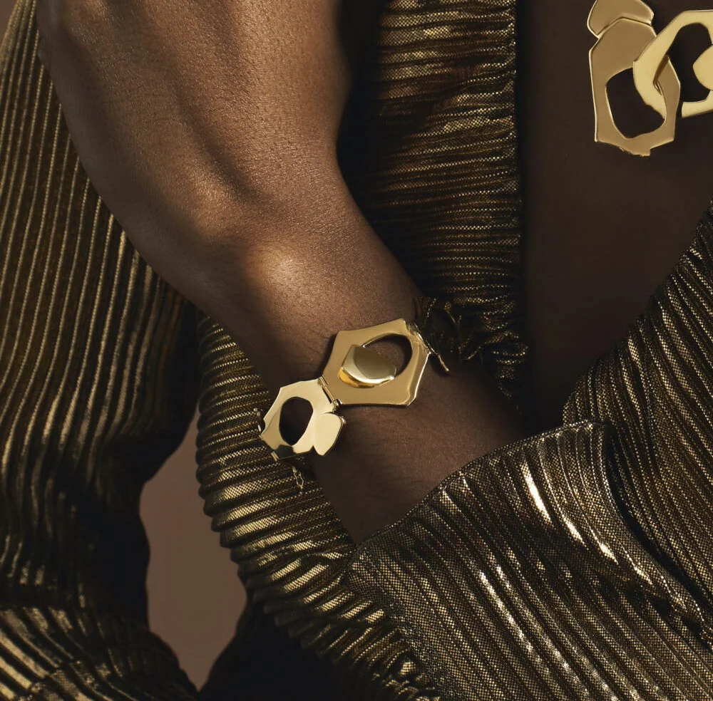 Gold tribute bracelet featuring modern geometric shapes, perfect for commemorative jewelry.