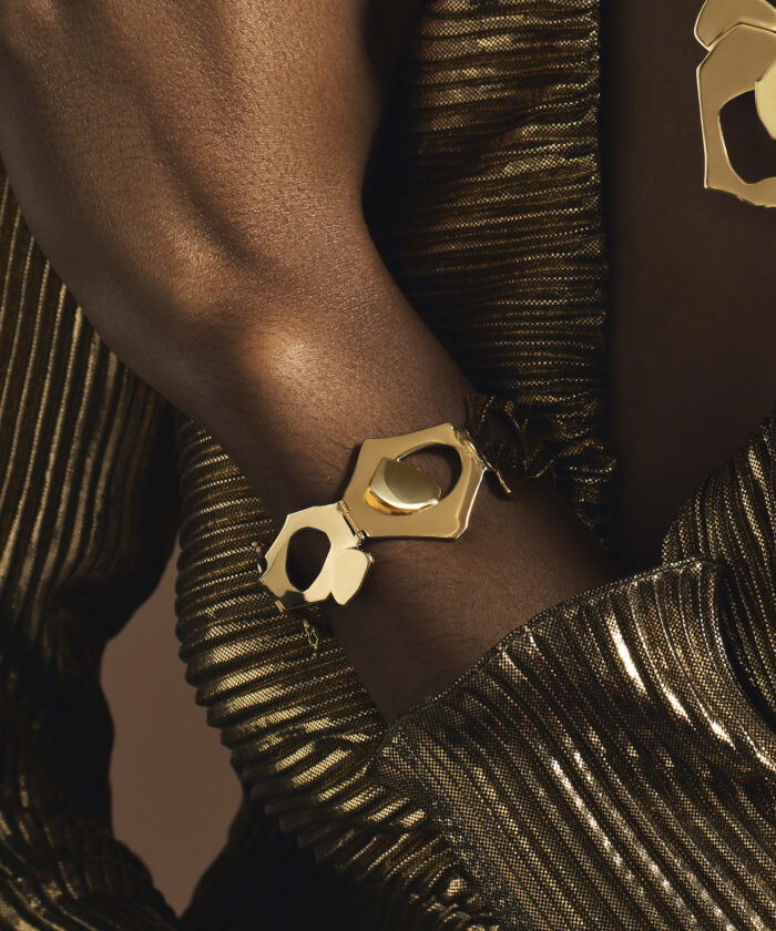 Gold tribute bracelet featuring modern geometric shapes, perfect for commemorative jewelry.