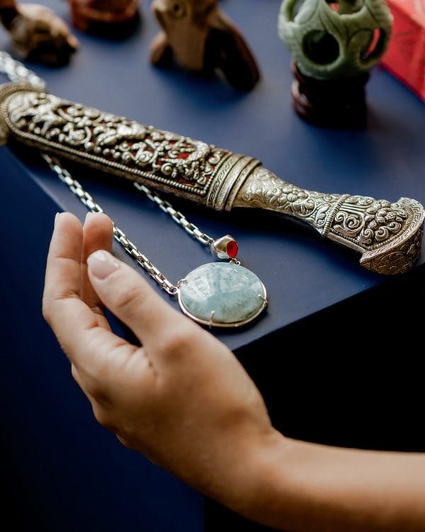 Elegant Larimar pendant necklace on silver chain showcasing handcrafted jewelry.