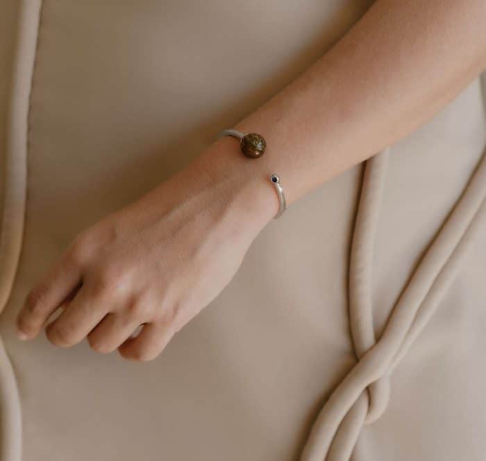 Amber bracelet with sleek metal accent, minimalist style for sophisticated look.