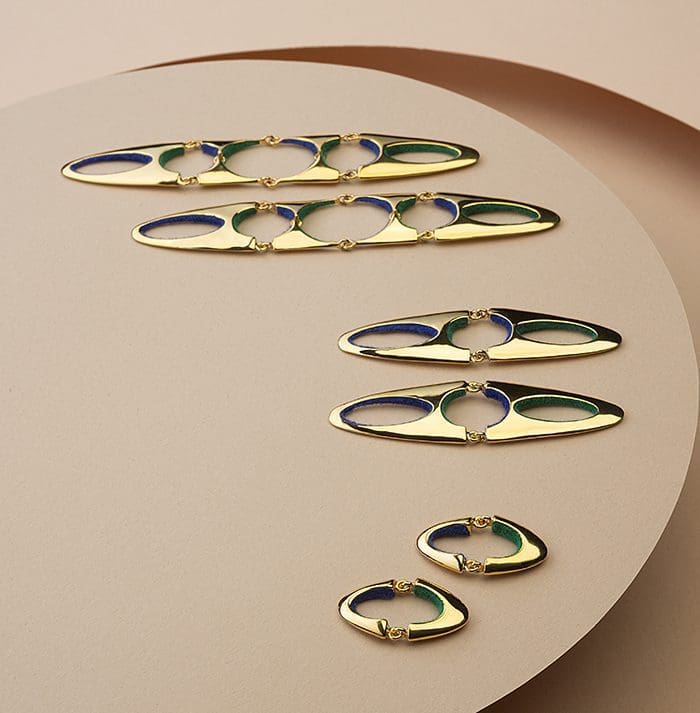 Colorful gold and navy jewelry, elegant hoop earrings, designer women's accessories.