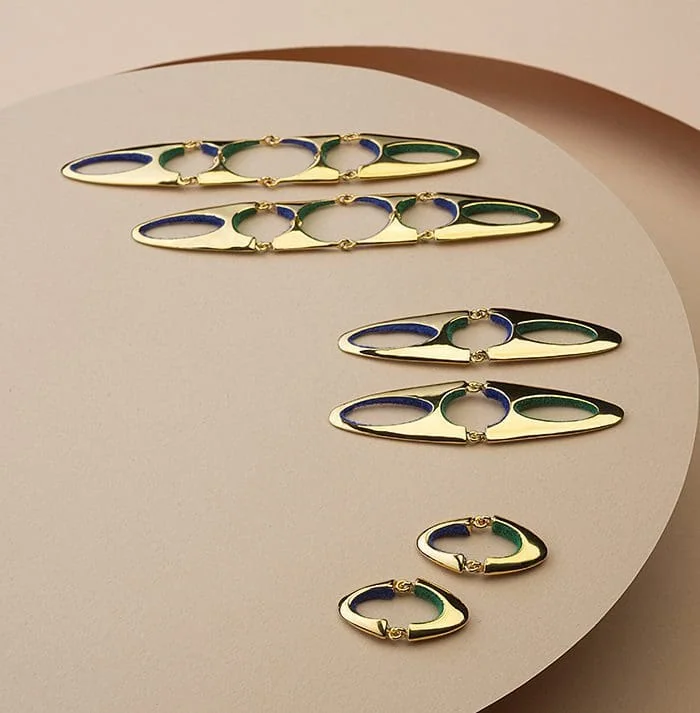 Colorful gold and navy jewelry, elegant hoop earrings, designer women's accessories.