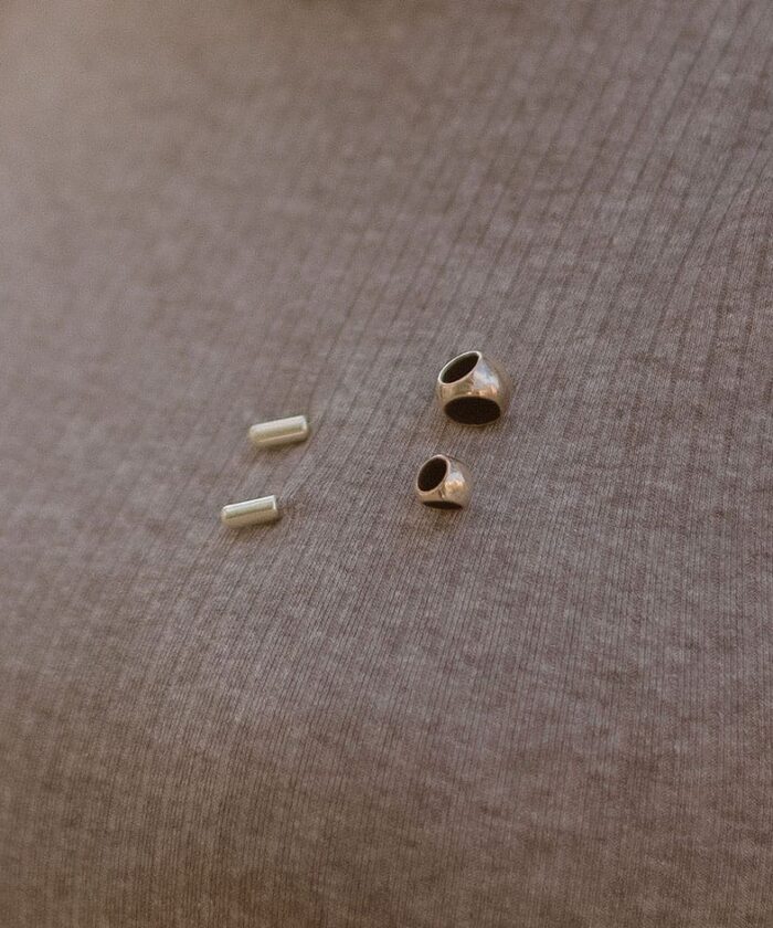 Close-up of jewelry accessories on fabric surface.