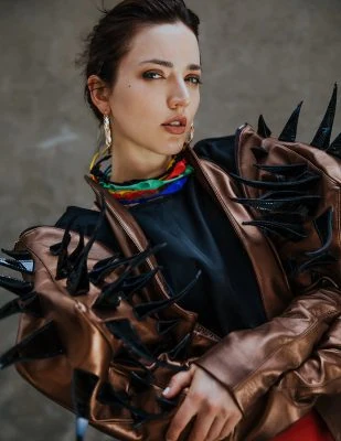 Vibrant fashion shot of Monica Varela with bold accessories and edgy style.