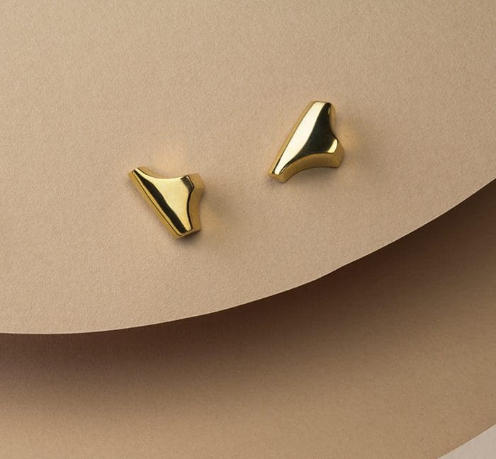 Gold Tannier stud earrings with sleek, modern design.