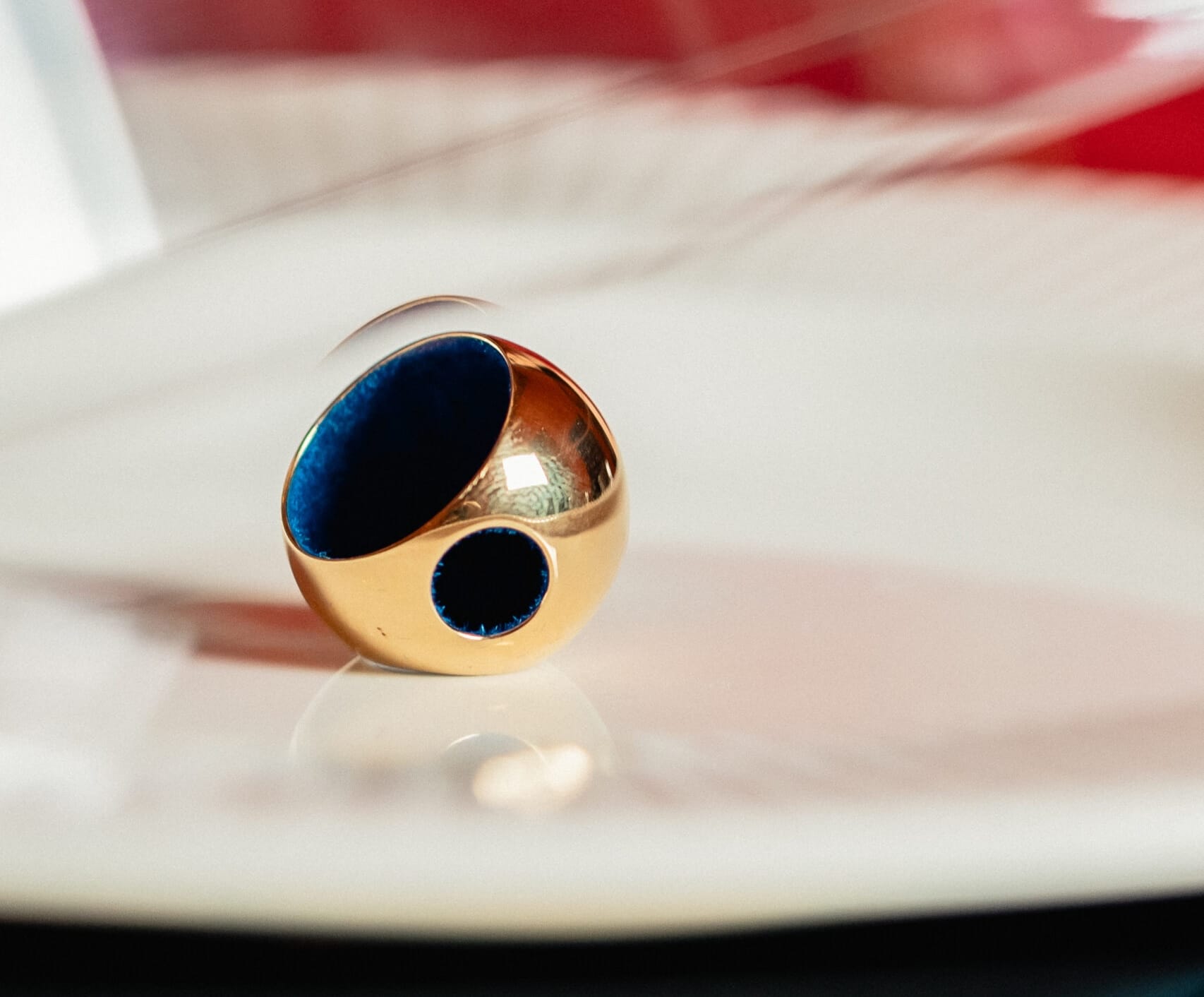 Huritá gold sphere with navy enamel, the seed of the Monica Varela design