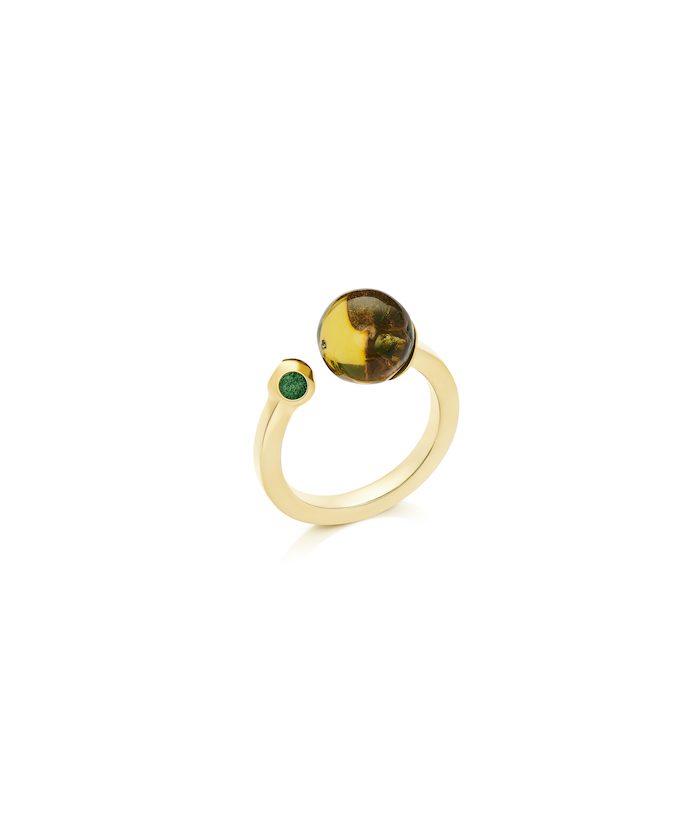 Delicate amber and green gemstone ring on gold band, stylish jewelry accessory.