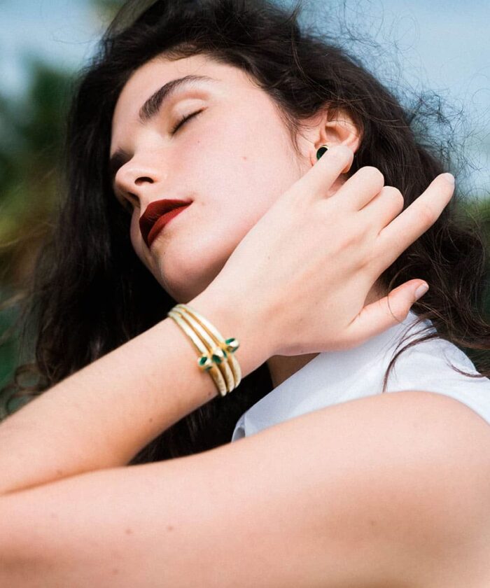 Close-up of woman wearing Trinity Cuff jewelry, stylish accessories, and natural beauty.