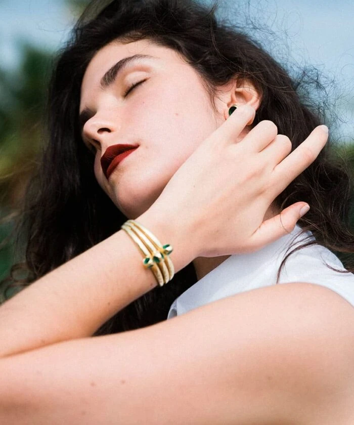 Close-up of woman wearing Trinity Cuff jewelry, stylish accessories, and natural beauty.