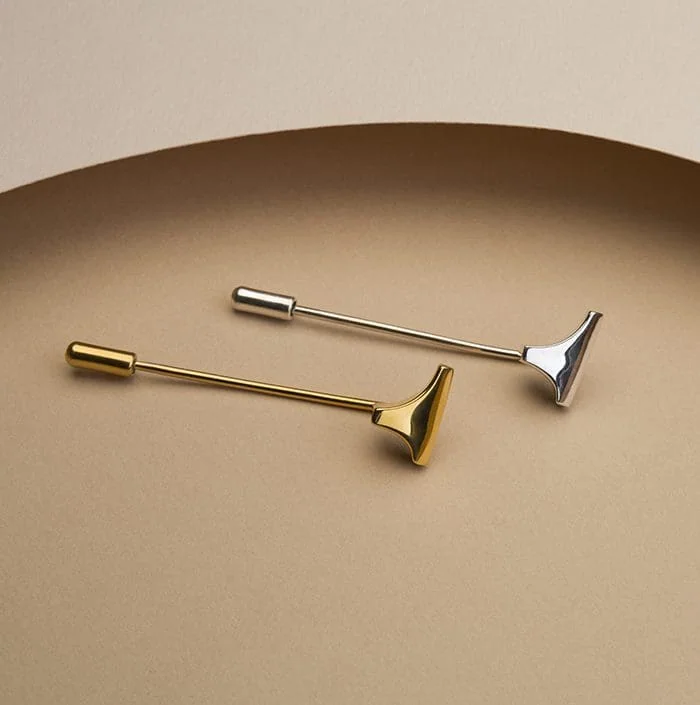 Stylish silver and gold T-shaped lapel pins, perfect for fashion accessories or modern decor.