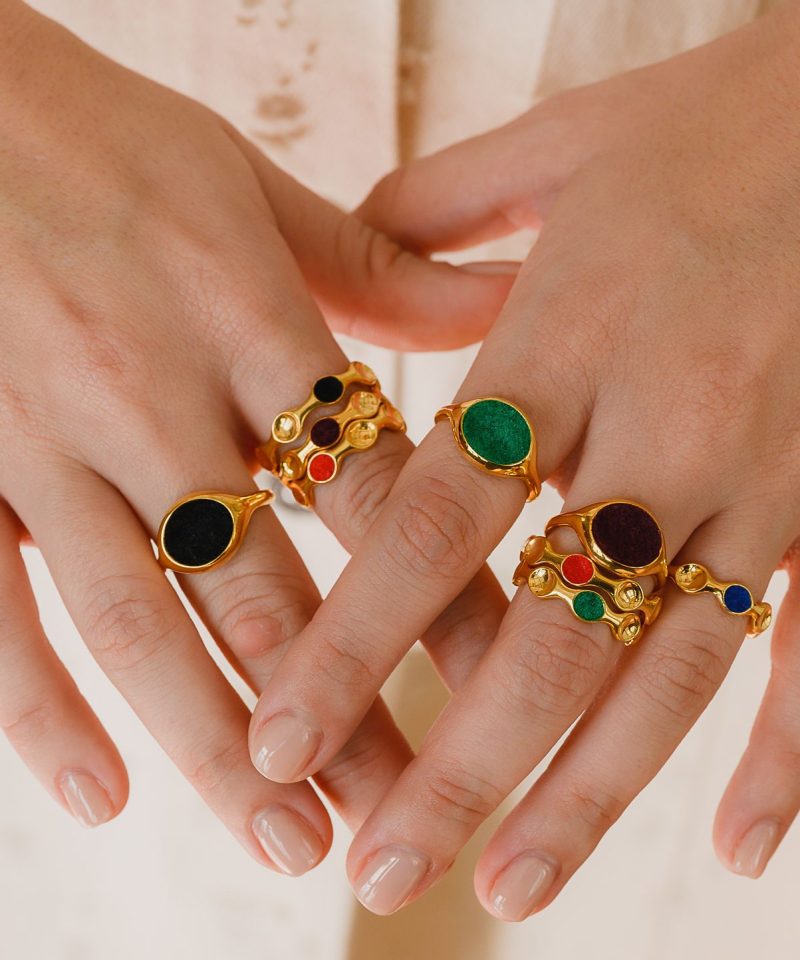 Beuo collection rings with colored enamel stacked on both hands