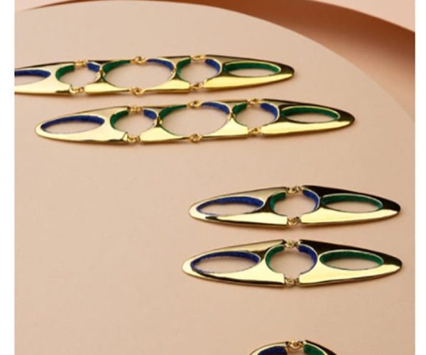 Vogue Mexico feature, gold and enamel earrings on a beige background