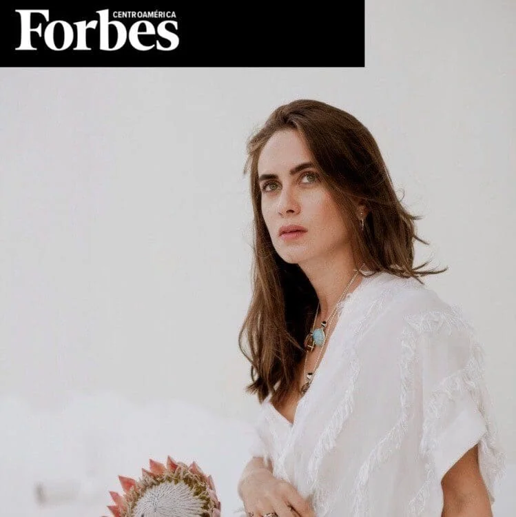 Stylish Monica Varela wearing white bohemian outfit with jewelry for Forbes coverage.