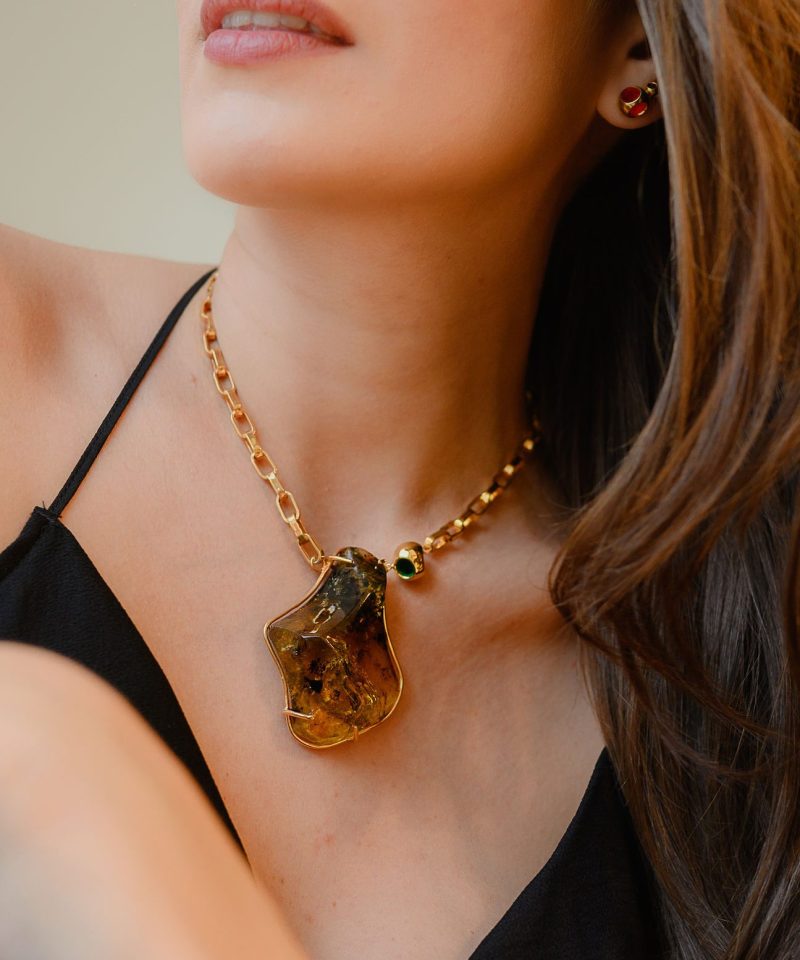 Minute Capsule amber pendant necklace worn by model