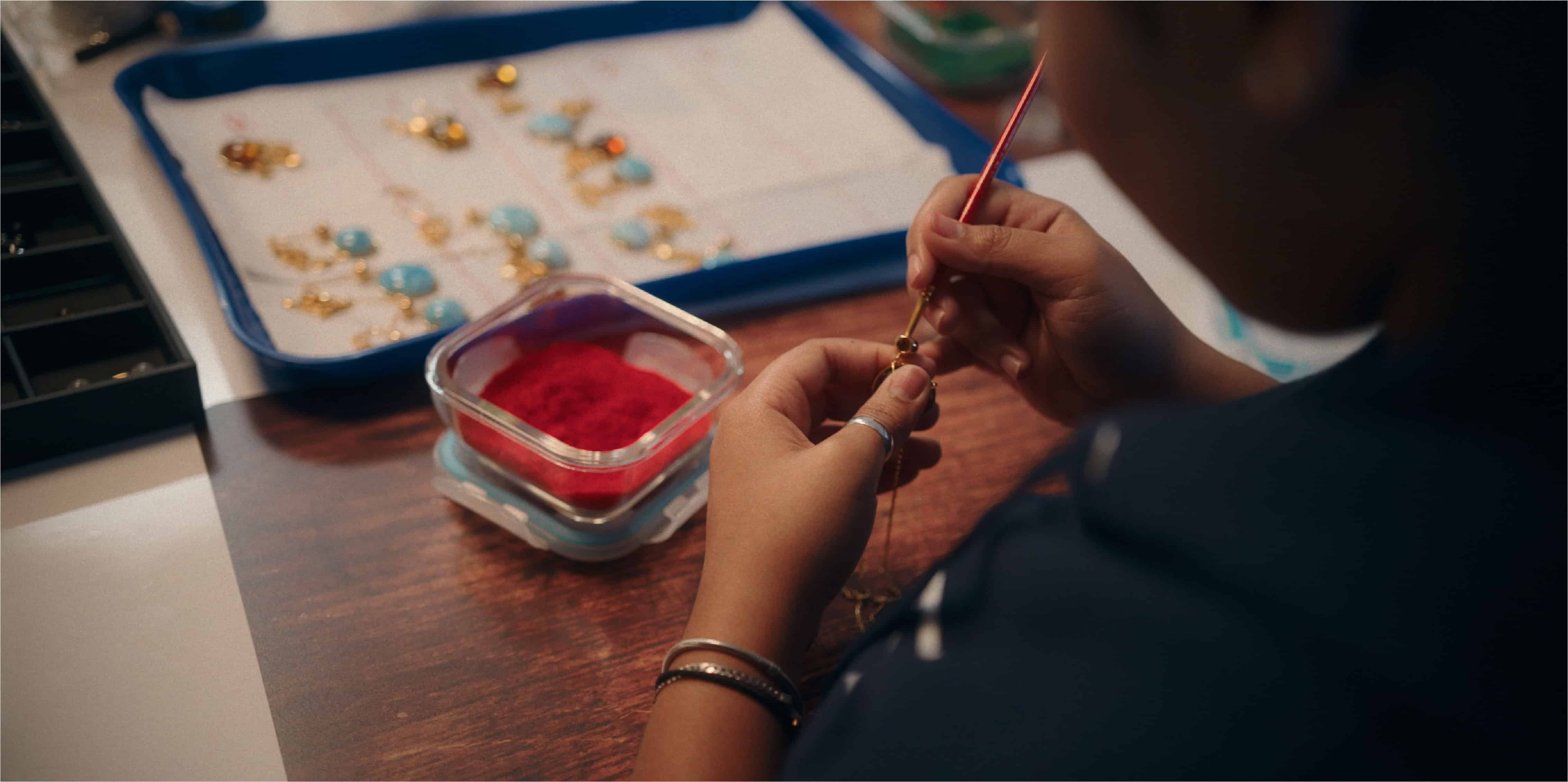 Artisan hand-painting enamel in the Monica Varela workshop