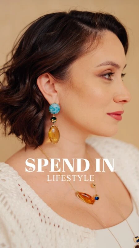 Beauty shot of woman with colorful earrings and necklace showcasing jewelry style.