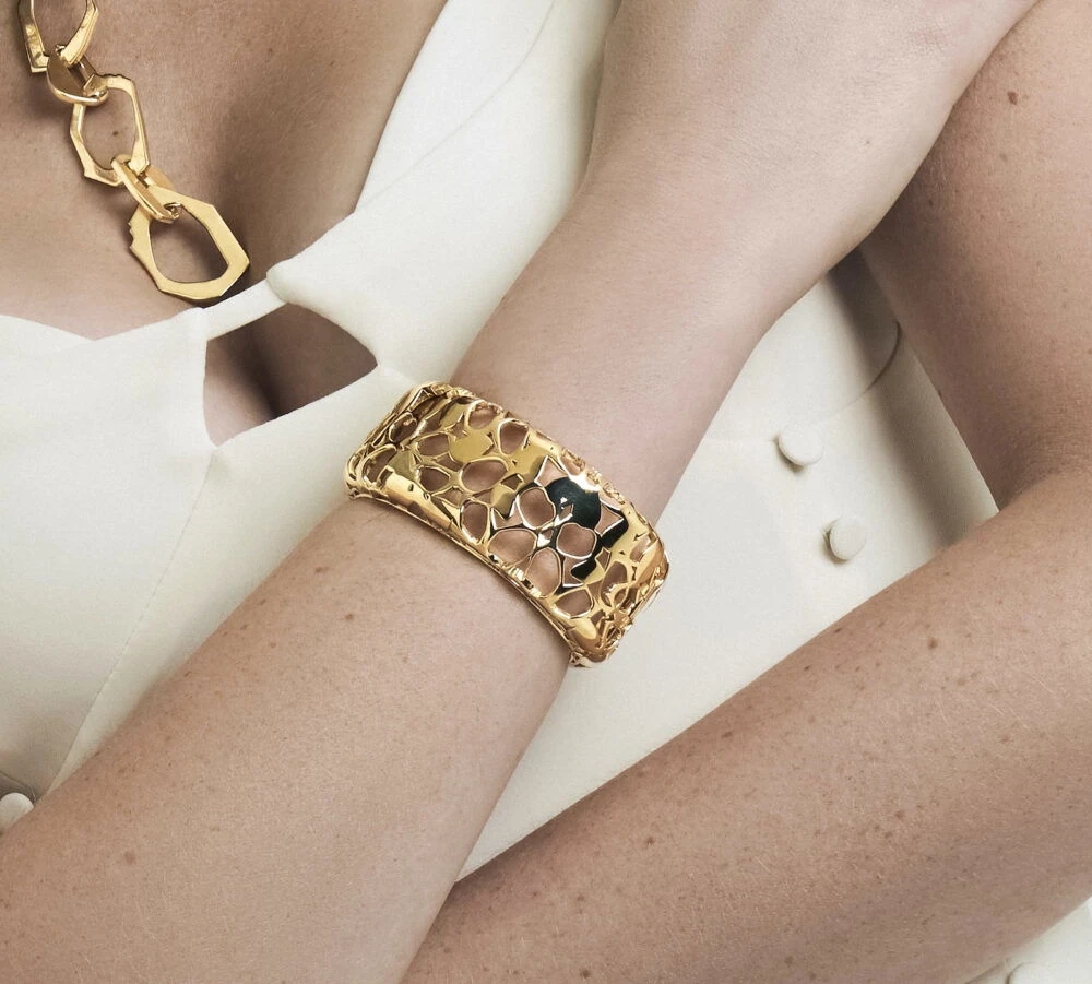 Luxurious gold leather bracelet with detailed cutout pattern for stylish accessorizing.