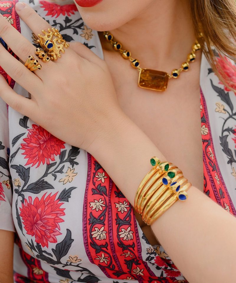 Yoem collection rings, bracelets and choker worn with a floral blouse